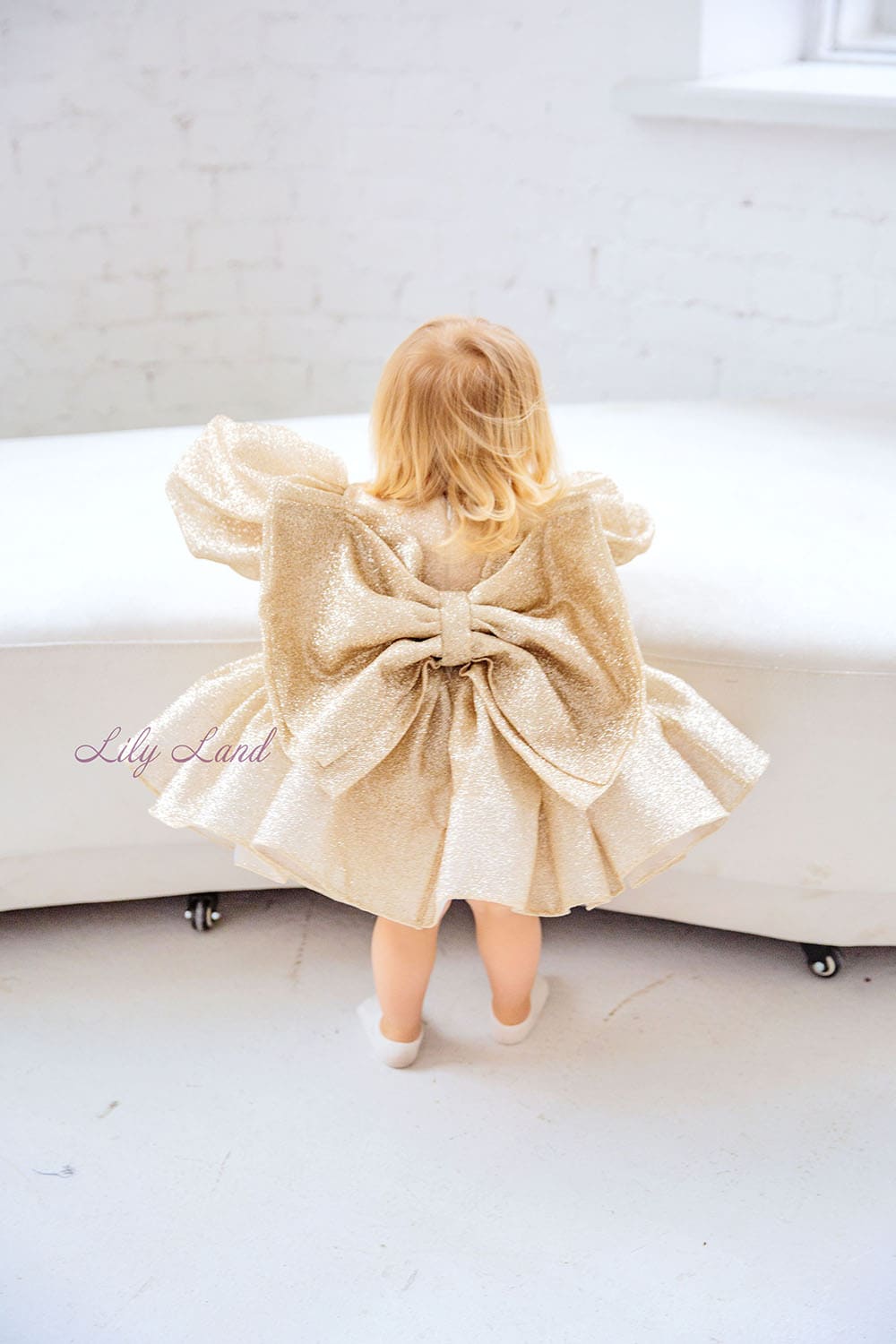 Goldie Girl Dress In Gold With A Huge Bow At The Back